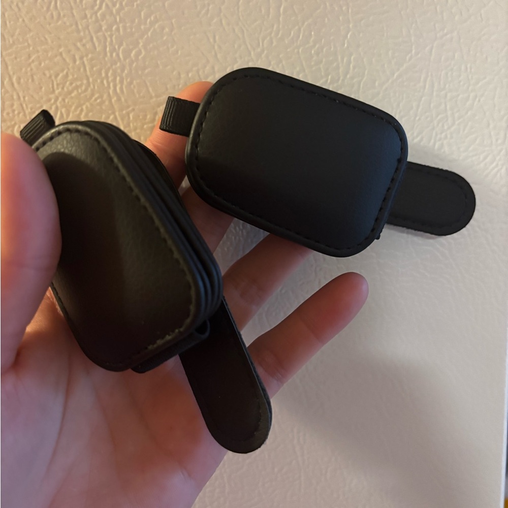 Black faux leather sunglasses holder for visor.